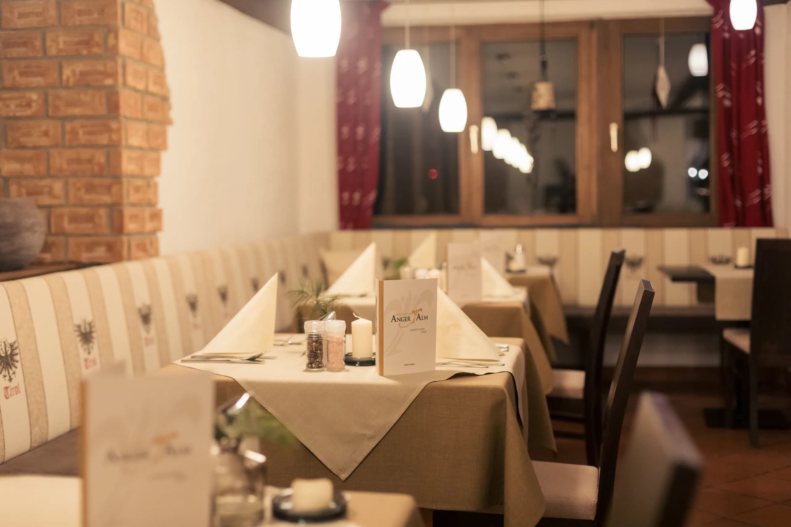 Gedeckter Restauranttisch am Fenster der Anger Alm
