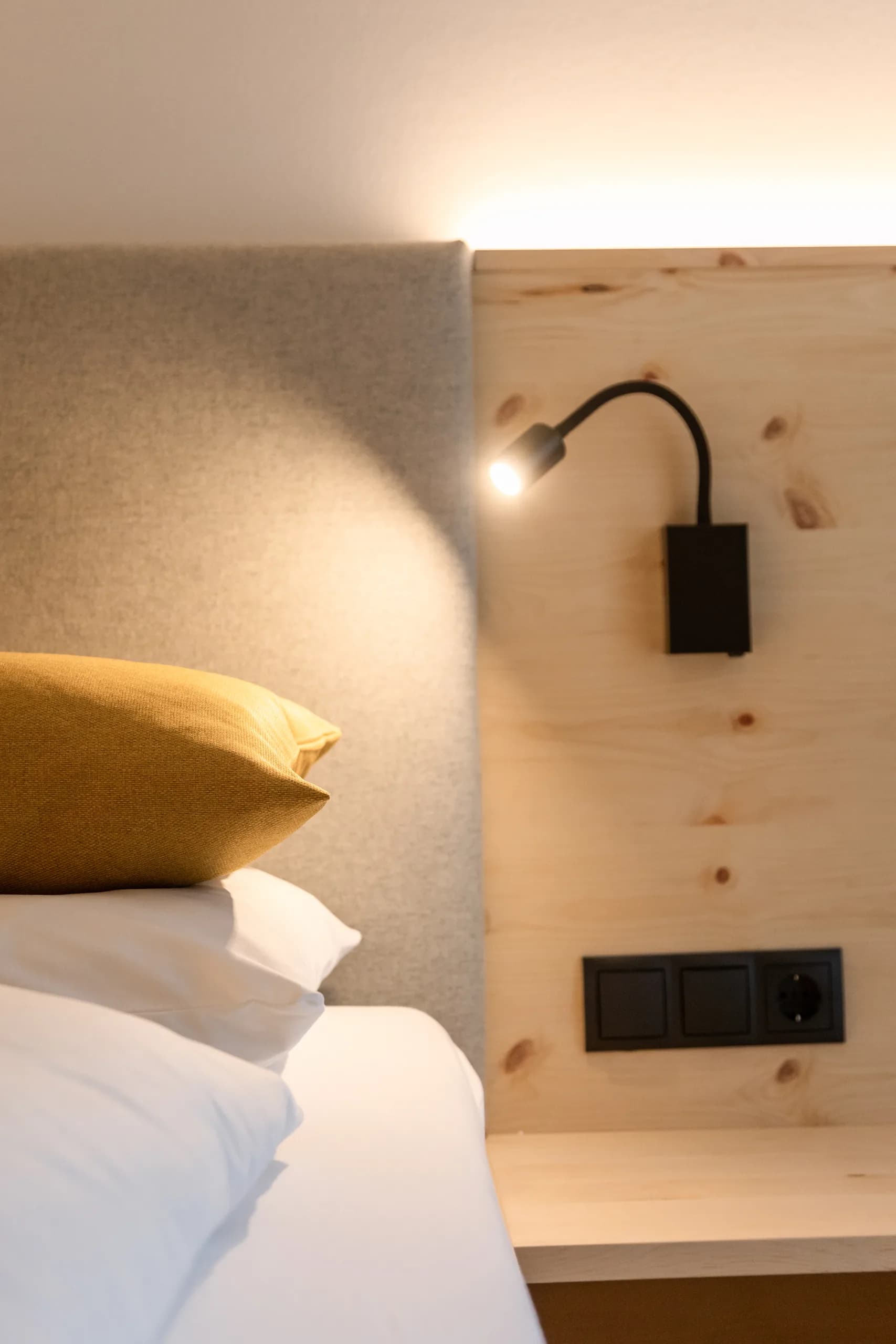 Detailaufnahme des Nachtkastens mit flexibler Leselampe im Zimmer Freiraum der Natur Residenz Anger Alm